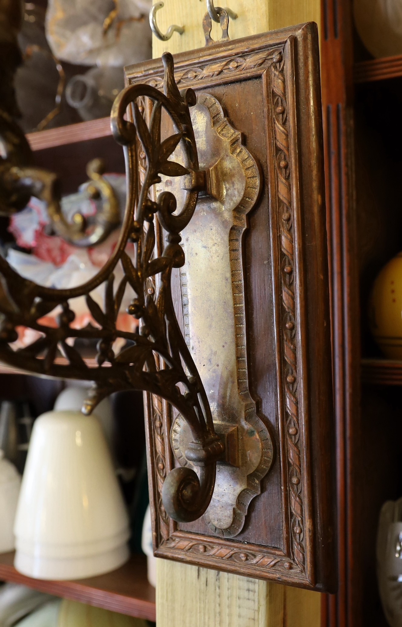 A late Victorian aesthetic movement ormolu wall bracket, modelled with Cupid and laurel leaves, mounted on an oak wallplate, height 34cm. depth 25cm